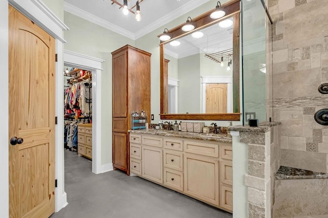 bathroom with double vanity, a tile shower, a sink, concrete floors, and ornamental molding
