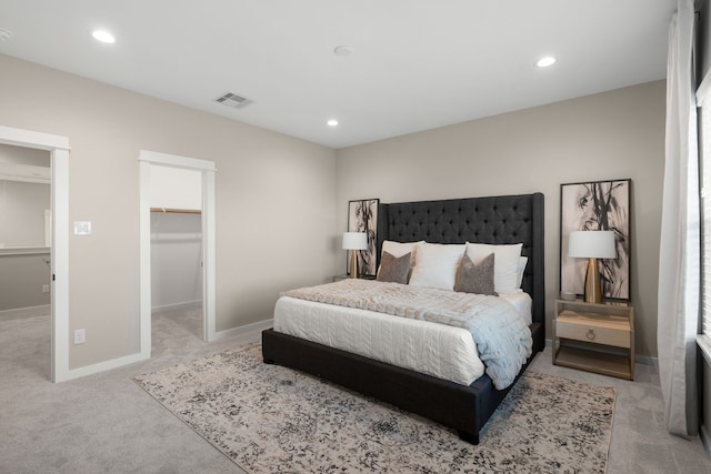 carpeted bedroom featuring visible vents, recessed lighting, and a spacious closet