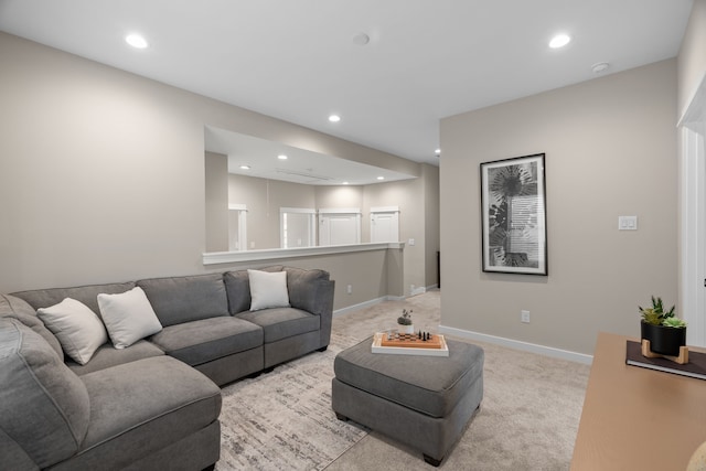 living room with recessed lighting, baseboards, and light colored carpet