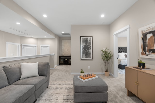 living room featuring baseboards, visible vents, recessed lighting, and light colored carpet