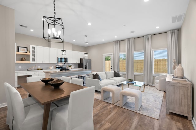 dining space featuring recessed lighting, visible vents, and wood finished floors
