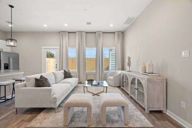living area with visible vents, recessed lighting, dark wood finished floors, and plenty of natural light