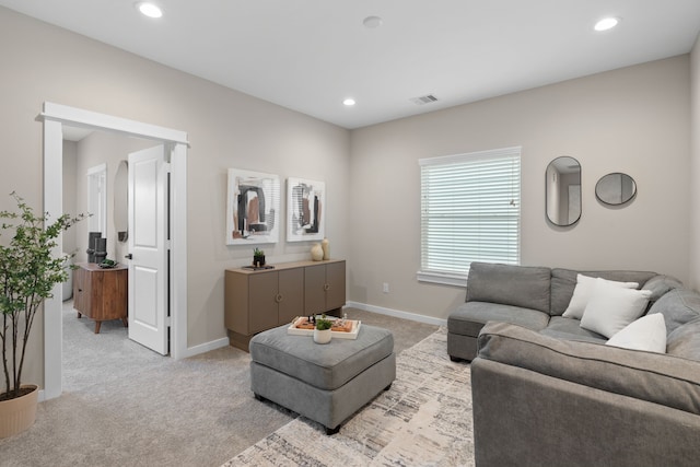 living room with recessed lighting, baseboards, and light colored carpet