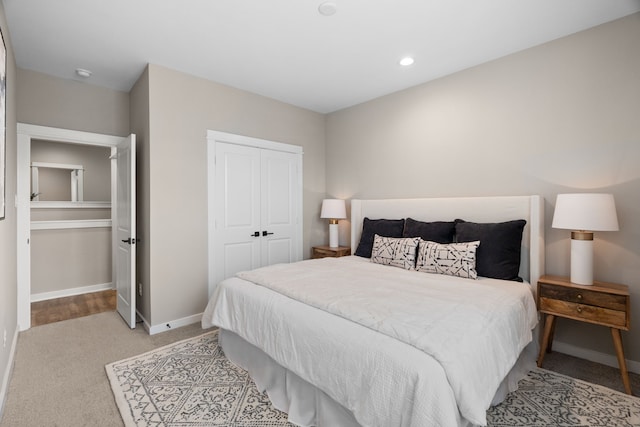 carpeted bedroom featuring baseboards, a closet, and recessed lighting