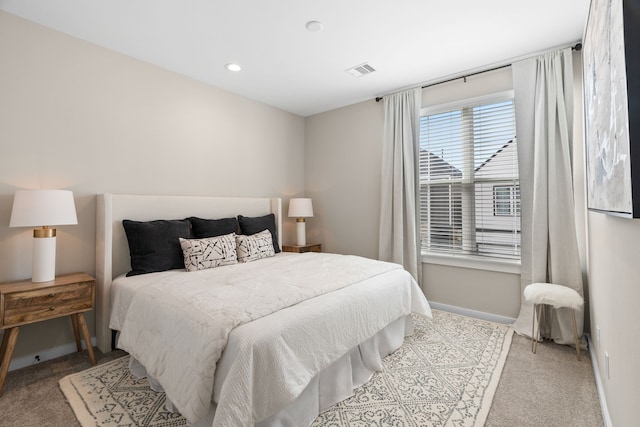bedroom with baseboards, visible vents, and carpet