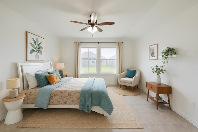 bedroom with baseboards, a ceiling fan, and light tile patterned floors