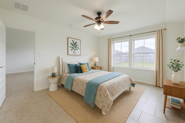 bedroom featuring light tile patterned floors, baseboards, a ceiling fan, and visible vents