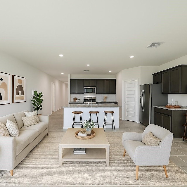 living area featuring recessed lighting, visible vents, and light tile patterned floors
