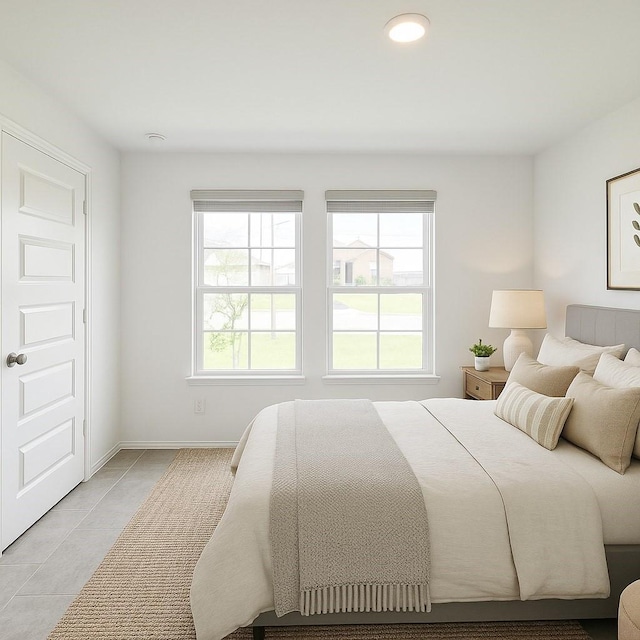 bedroom with light tile patterned flooring and baseboards