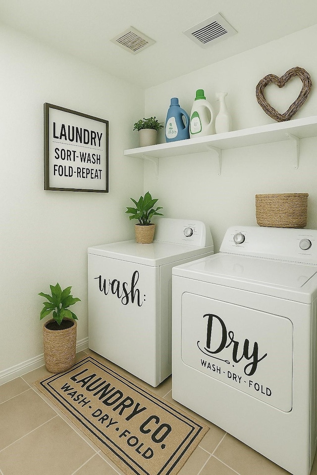 laundry room featuring light tile patterned floors, separate washer and dryer, laundry area, and visible vents