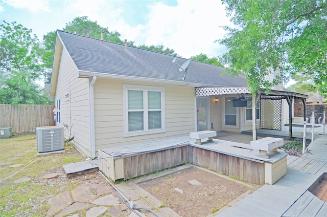 16806 Ashmoor Way, Houston, TX 77058 - rear view of property featuring a wooden deck, central air condition unit, and a shingled roof