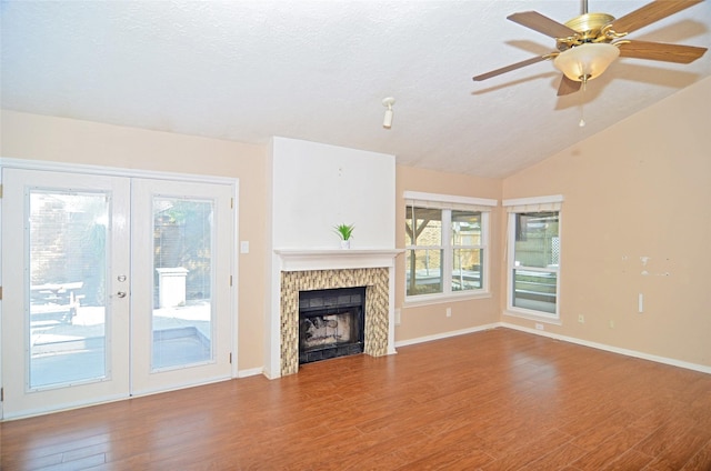 16806 Ashmoor Way, Houston, TX 77058 - unfurnished living room featuring french doors, wood finished floors, vaulted ceiling, baseboards, and a fireplace