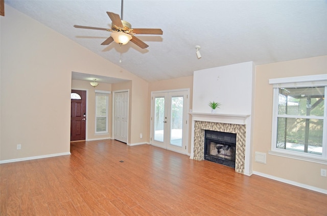 16806 Ashmoor Way, Houston, TX 77058 - unfurnished living room featuring french doors, vaulted ceiling, healthy amount of natural light, ceiling fan, and light wood-type flooring