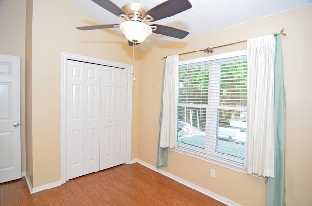 16806 Ashmoor Way, Houston, TX 77058 - unfurnished bedroom with wood finished floors, baseboards, a closet, and ceiling fan