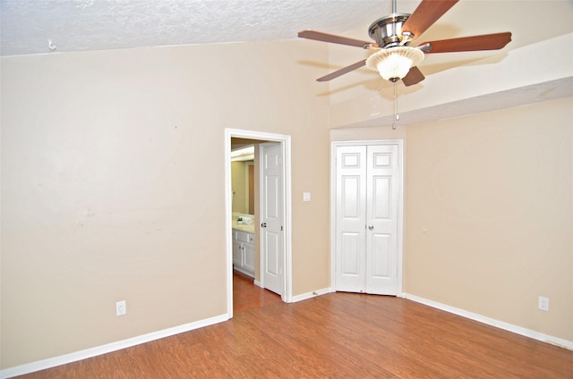 16806 Ashmoor Way, Houston, TX 77058 - unfurnished room with wood finished floors, ceiling fan, baseboards, and a textured ceiling