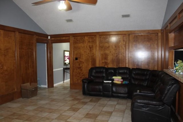 9222 Chesney Downs Dr, Houston, TX 77083 - living room featuring ceiling fan, high vaulted ceiling, light tile patterned floors, and wooden walls