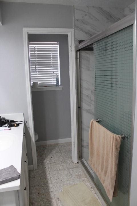 9222 Chesney Downs Dr, Houston, TX 77083 - full bath with vanity, a shower stall, toilet, and baseboards