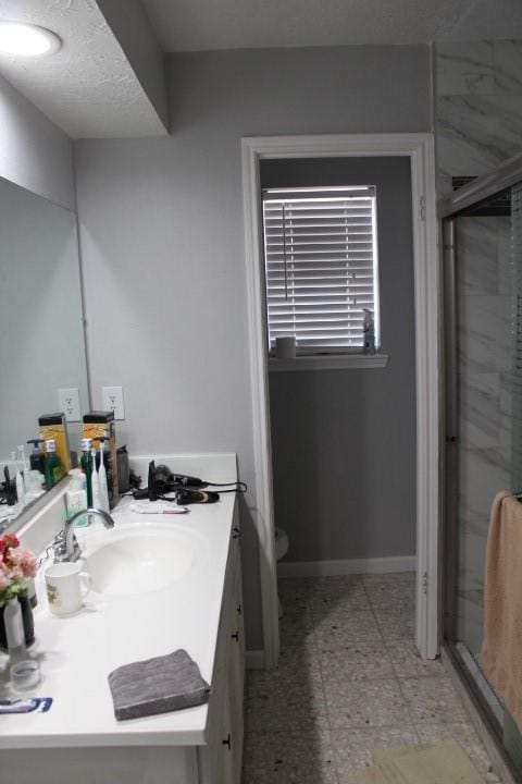 9222 Chesney Downs Dr, Houston, TX 77083 - bathroom with vanity, a shower stall, toilet, and baseboards