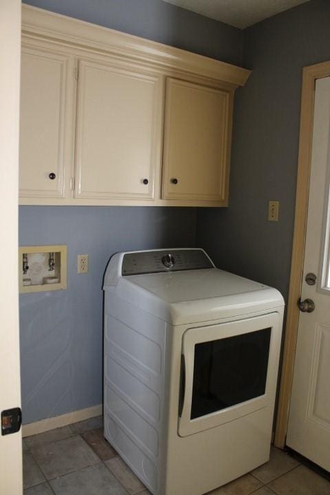 9222 Chesney Downs Dr, Houston, TX 77083 - laundry room with washer / clothes dryer, cabinet space, baseboards, and light tile patterned floors