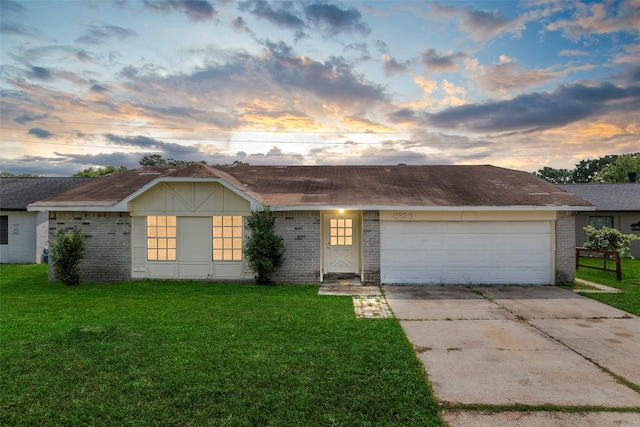 ranch-style house featuring brick siding, a yard, and concrete driveway