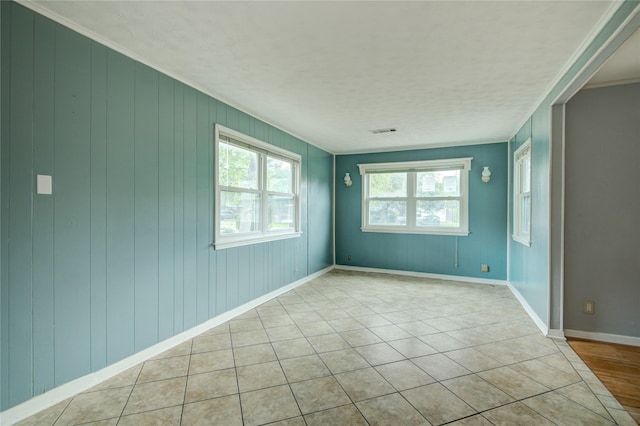 1622 Jennifer Ln, Houston, TX 77029 - empty room featuring visible vents, ornamental molding, baseboards, and light tile patterned floors