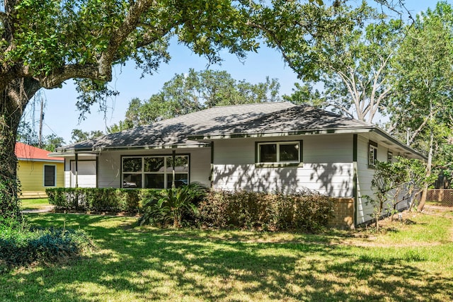 5006 Live Oak Dr, Texas City, TX 77591 - ranch-style home with fence, a shingled roof, and a front lawn