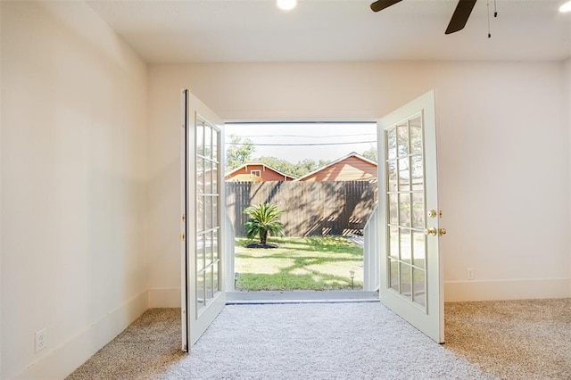doorway to outside featuring a healthy amount of sunlight, french doors, and carpet