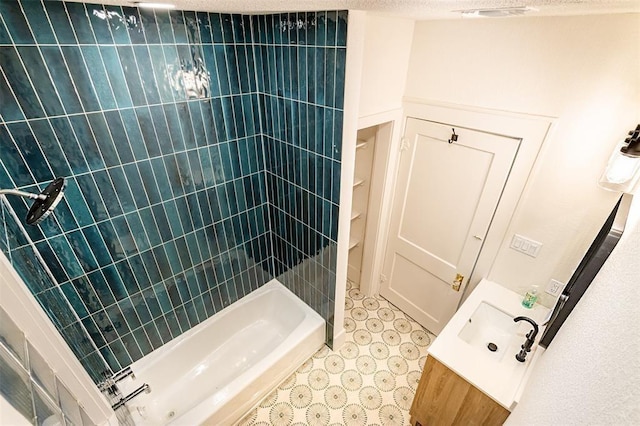 bathroom featuring vanity, a tile shower, and visible vents