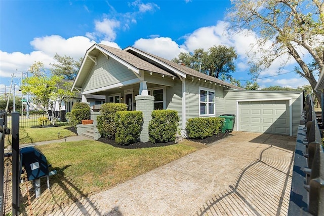 view of front of home with concrete driveway, an attached garage, and a front yard