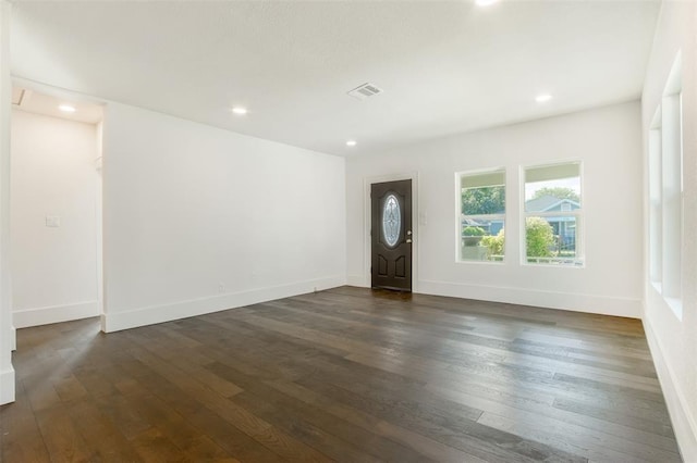 entryway with baseboards, visible vents, and dark wood-style floors