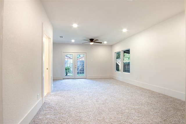 spare room featuring carpet floors, a ceiling fan, recessed lighting, and a wealth of natural light