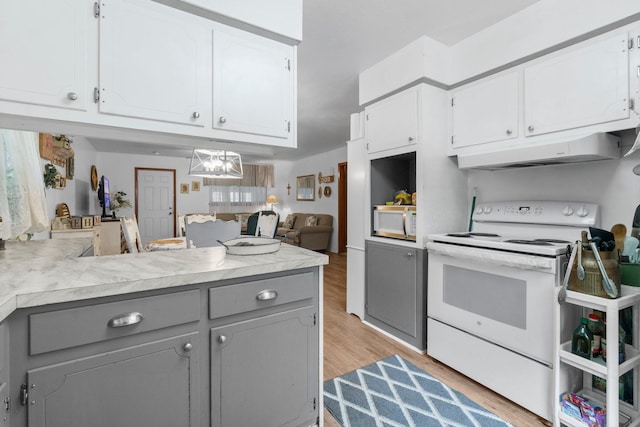 kitchen featuring gray cabinets, under cabinet range hood, white appliances, and white cabinets
