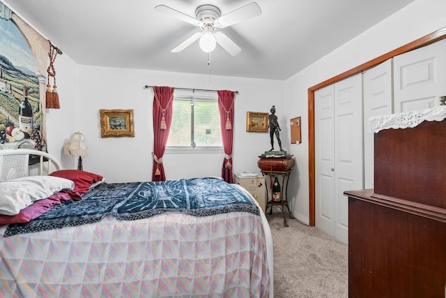 bedroom featuring a ceiling fan, a closet, and light colored carpet