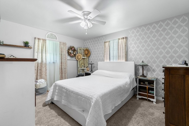 bedroom with carpet, a ceiling fan, and wallpapered walls