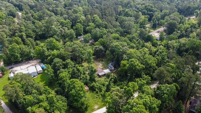 birds eye view of property featuring a view of trees