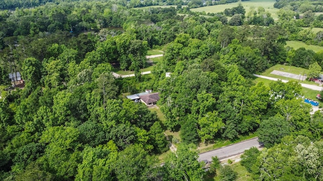 birds eye view of property with a view of trees