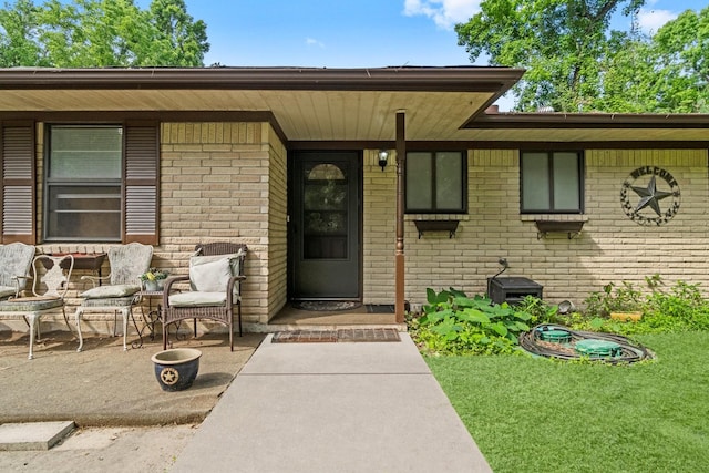doorway to property featuring brick siding