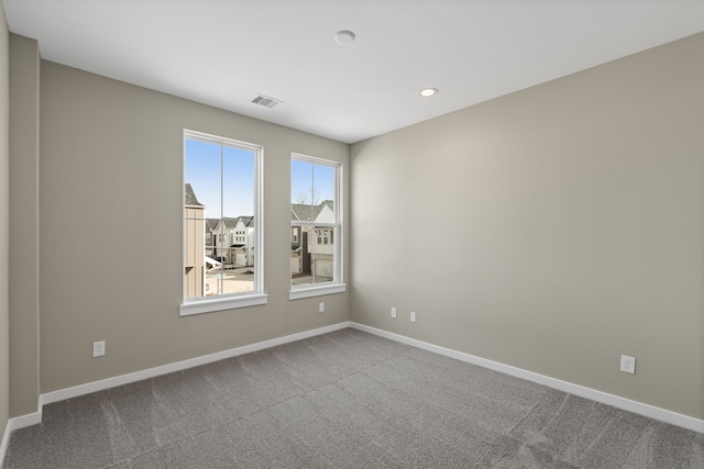 carpeted empty room featuring baseboards, recessed lighting, and visible vents