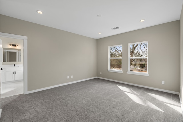carpeted empty room with visible vents, recessed lighting, and baseboards