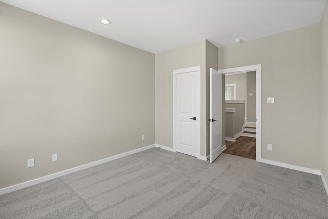 unfurnished bedroom with recessed lighting, baseboards, and carpet