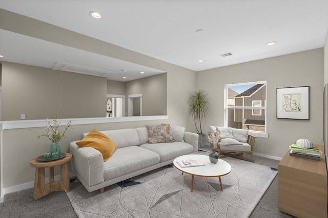 carpeted living room with visible vents, attic access, baseboards, and recessed lighting