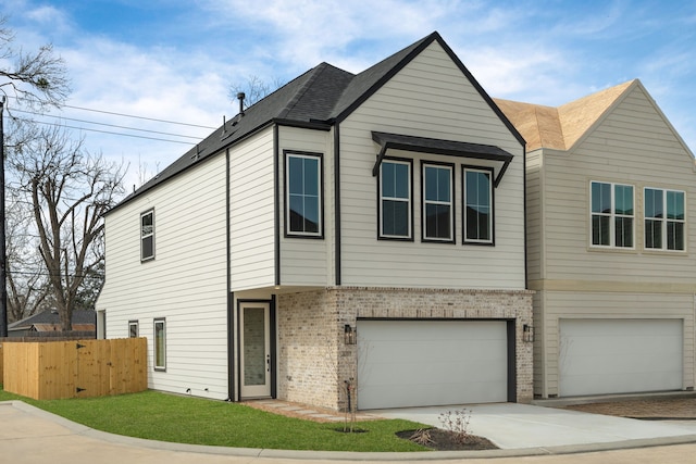 multi unit property featuring fence, roof with shingles, an attached garage, brick siding, and driveway