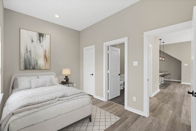 bedroom featuring recessed lighting, baseboards, a chandelier, and wood finished floors