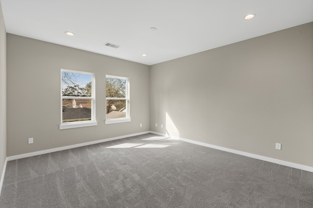 carpeted empty room with visible vents, recessed lighting, and baseboards