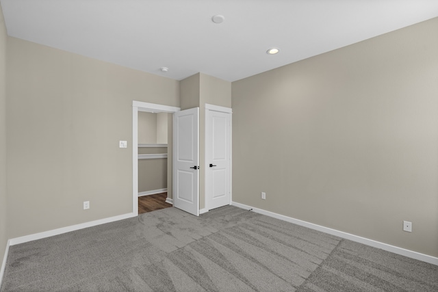 unfurnished bedroom featuring carpet floors, recessed lighting, and baseboards