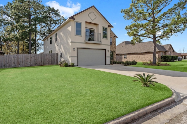 view of front facade with fence, an attached garage, stucco siding, a front yard, and a balcony
