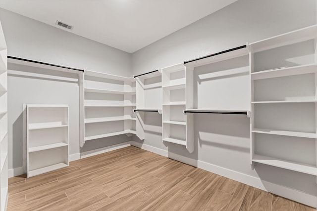 walk in closet with visible vents and wood finished floors