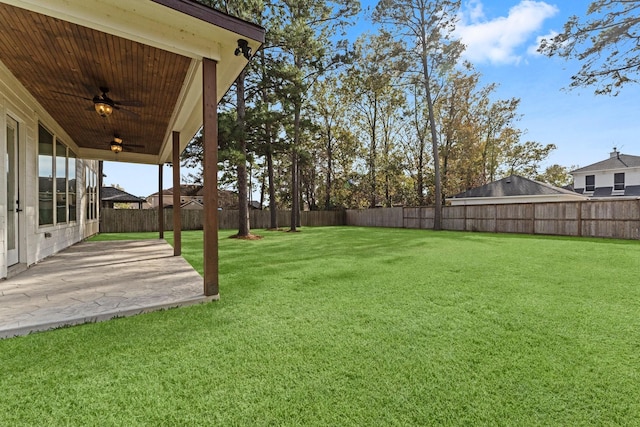 view of yard with a patio, a ceiling fan, and a fenced backyard
