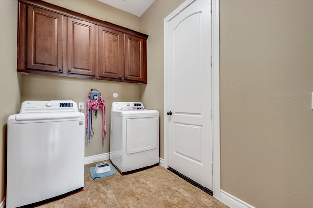 6119 Lofty Ln, Spring, TX 77379 - clothes washing area featuring washing machine and clothes dryer, cabinet space, and baseboards