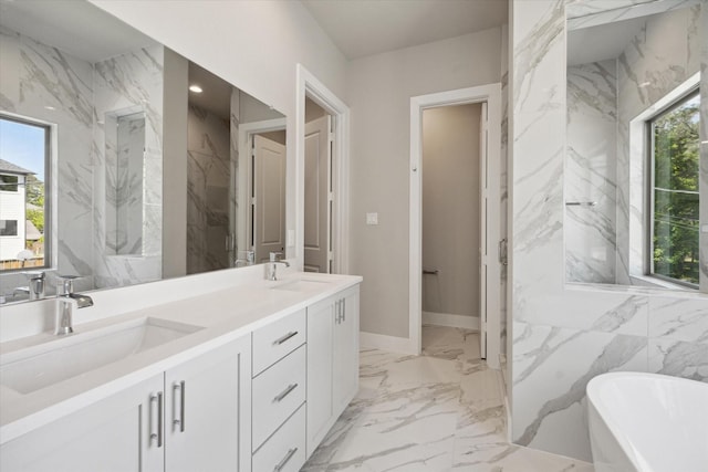 540 Janisch Rd Unit F, Houston, TX 77018 - bathroom featuring double vanity, a freestanding tub, marble finish floor, baseboards, and a sink